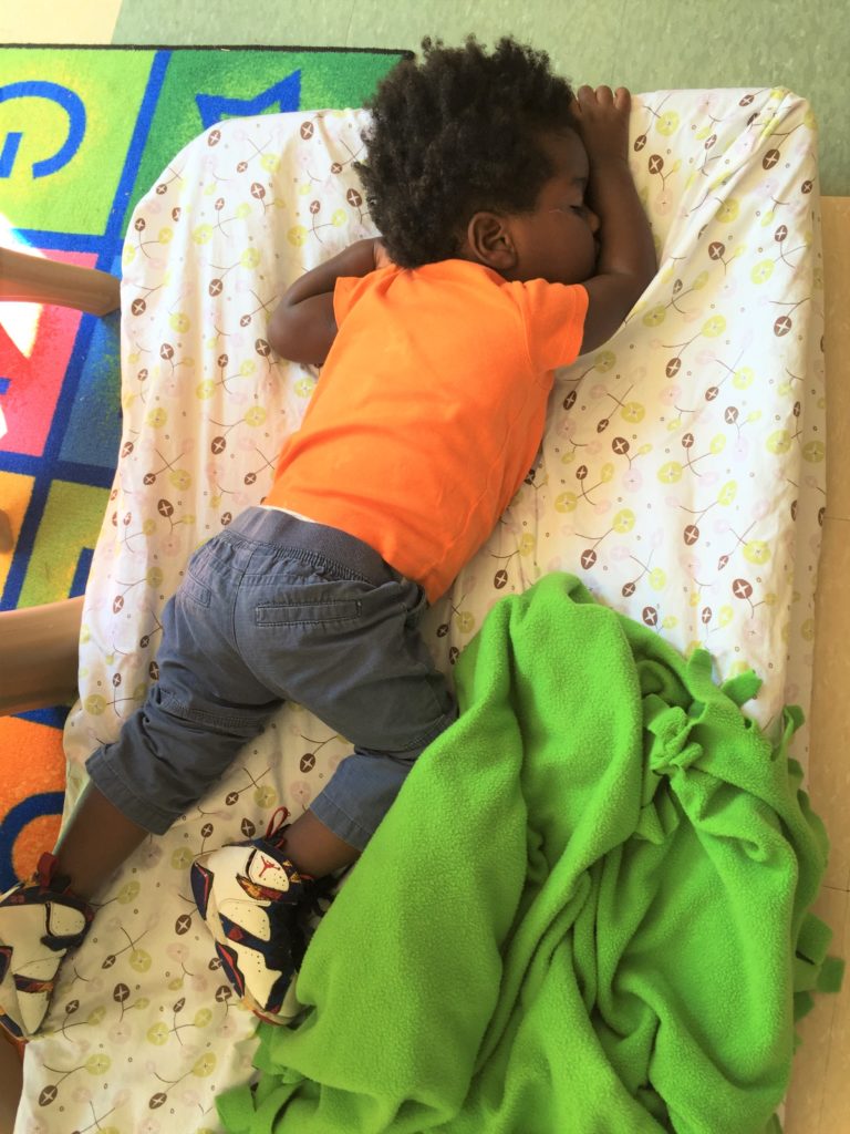Child sleeping on a cot. 