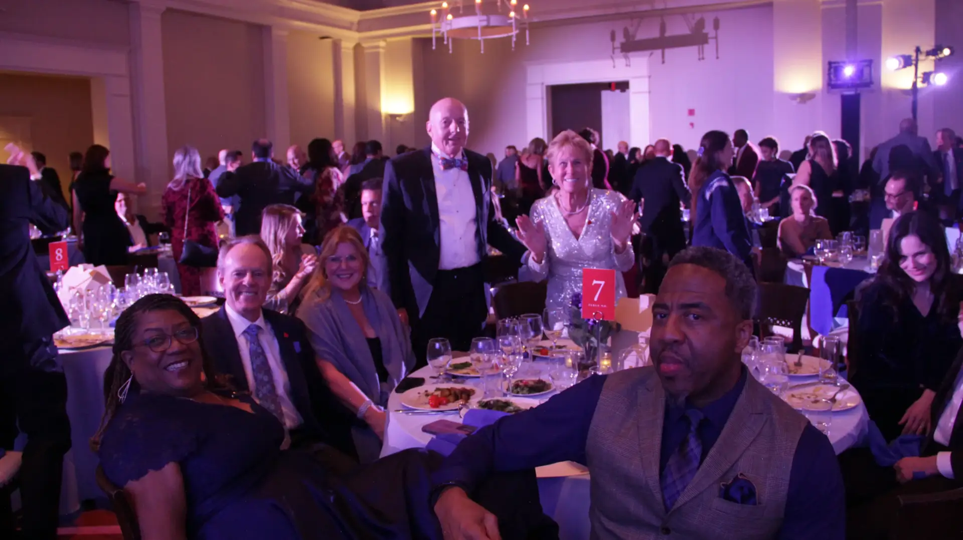 Guests smiling at their table during a past OH What a Night gala